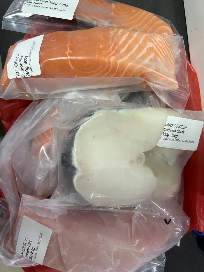 Sealed packs of fish fillets, each labelled